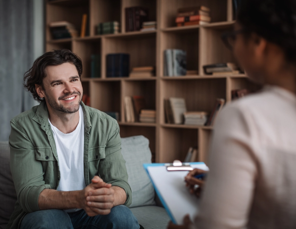 Man in green shirt talking to therapist.