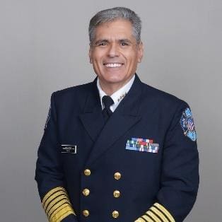 A man in military uniform standing next to a wall.