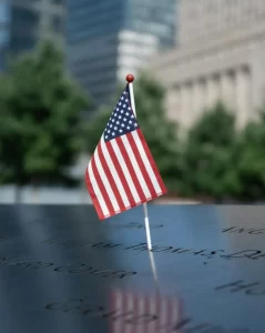 Small American flag on engraved memorial